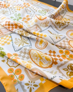 Detailed close-up of vibrant satin scarf with lobster and sardine print pattern