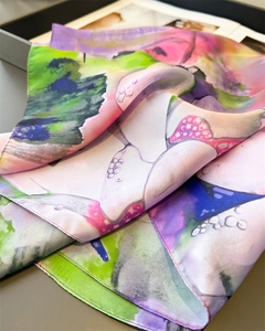 Detailed close-up of smooth silk scarf with colorful lotus pond watercolor print texture