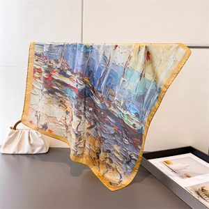 Detail of oil painting style silk scarf showing intricate abstract print and rolled edges