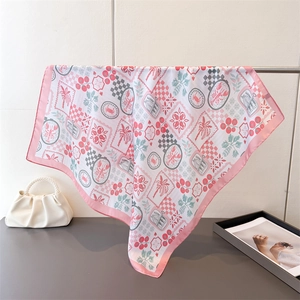 Detail of floral silk scarf with lobster and palm tree patterns on a metal stand