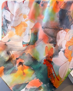 Detailed view of dragonfly and lotus print on silk scarf with elegant drape and luster