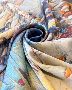 Macro shot of silk scarf showing glossy texture and artistic oil painting patterns
