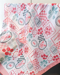 Detailed view of lightweight silk scarf featuring lobster, sardine, and palm leaf patterns