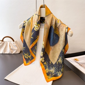 Artistic oil painting silk scarf with yellow and blue print draped on a white top