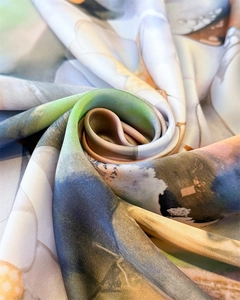 Macro shot of abstract dragonfly print silk scarf with satin luster and soft fabric folds