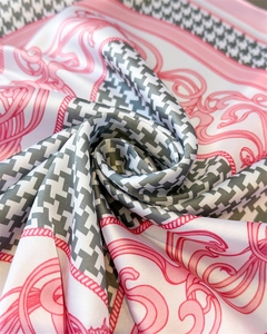 Detailed close-up of pink and grey houndstooth silk scarf showing smooth texture