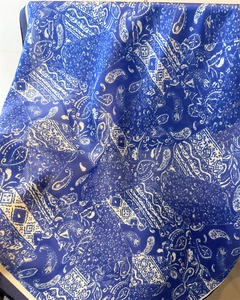 Détail d'un foulard en soie imprimé cachemire bleu et blanc avec texture douce et fluide