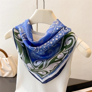 Blue and green paisley silk square scarf tied on a white top for styling