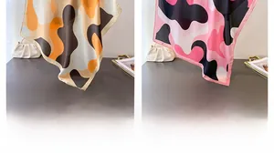 Abstract geometric silk scarf set in warm orange and pink tones with smooth rolled edges