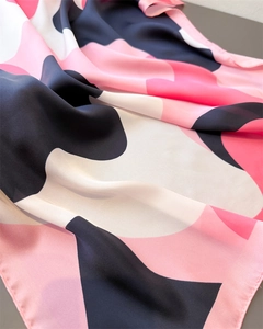 Detailed view of abstract geometric silk scarf with fine stitching and soft texture