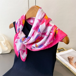 Detailed view of floral silk scarf featuring elegant pink and purple floral print texture