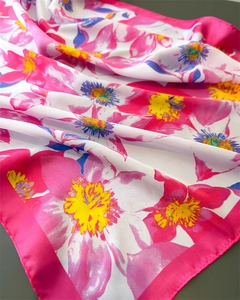 Detailed view of vibrant floral silk scarf with soft pleats and glossy satin texture