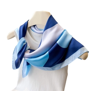Minimalist silk square scarf with blue and white geometric patterns on mannequin