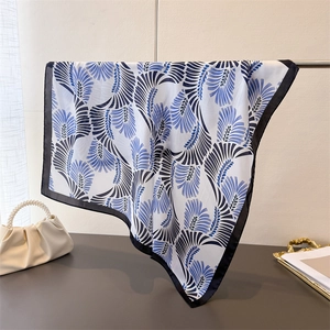 Elegante sciarpa in seta con motivi a piume Art Déco blu drappeggiati su barra di metallo