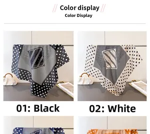 Detail view of polka dot and geometric print silk scarves in black and white colors