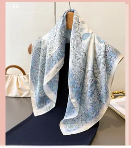 Detail of blue and white paisley silk scarf hanging elegantly on a wooden hanger