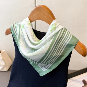 Elegant green floral square silk scarf tied on a hanger with aesthetic plant leaf pattern