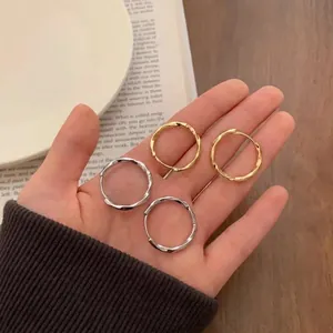 Set di orecchini a cerchio intrecciati oro e argento in uno stile di vita minimal