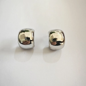 Detailed view of large silver geometric square earrings with a high-polished mirror finish