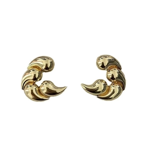 Macro detail of gold-plated sculptural earrings with triple tiered crescent design