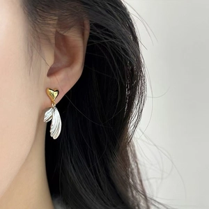 Fashionable heart and fishtail dangle earrings with S925 silver needle on female model