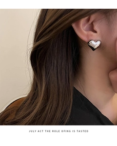Close-up of a 3D heart-shaped S925 sterling silver stud earring on a model's ear