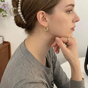 Elegant gold twisted horn hoop earrings and matching ring set in minimalist French style