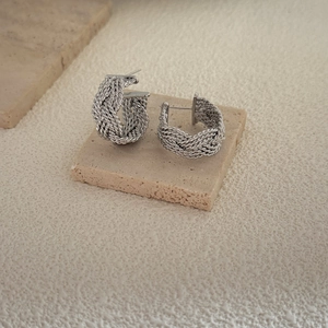 Silver woven textured hoop earrings with multi-strand knotted C-shape design on stone