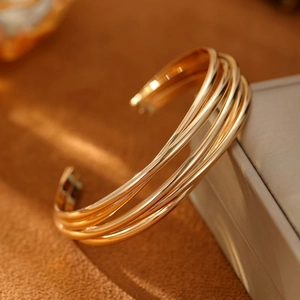 Polished 18K gold plated multi-layer curved bangle with adjustable open design