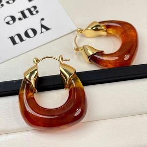 Chic amber resin drop earrings with gold metal accents in a retro geometric design