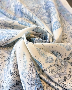 Detail of silk-like blue paisley fabric showing smooth texture and elegant drape