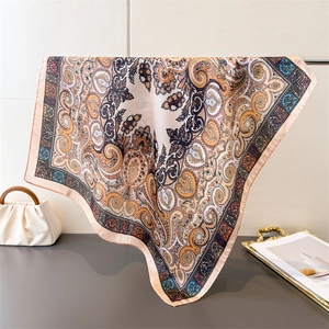 Elegant paisley print silk-like square scarf in peach and blue for versatile styling