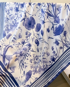Detailed view of dark blue floral print silk scarf with elegant botanical patterns