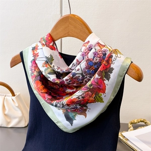 Floral print satin silk scarf draped on a wooden hanger with a floral pattern