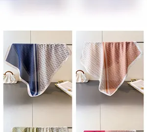 Detail display of printed silk scarves in navy blue and light brown with geometric patterns