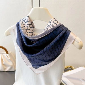 Elegant navy blue and white silk scarf with repeating logo pattern for stylish women