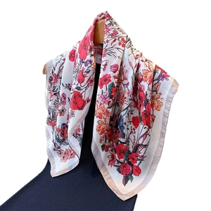 Floral print silk square scarf featuring vivid red and orange blossoms on white background