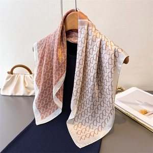 Elegant silk-like square scarf with pink and cream D-letter print on a hanger