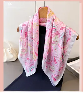 Close-up of pink paisley silk scarf with fine rolled edges on a wooden hanger