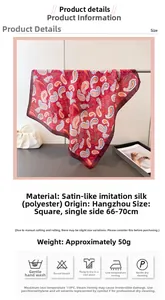 Detailed view of red paisley square scarf featuring elegant satin finish and rolled edges