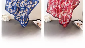 Detail of silk scarf showing navy and red paisley patterns with premium satin texture