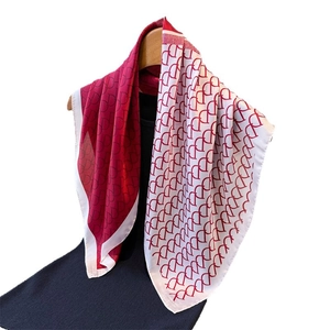 Elegant red and white color-block silk scarf with geometric pattern on wooden hanger