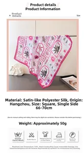 Detail of satin floral silk scarf with tropical prints and beach elements on a hanger
