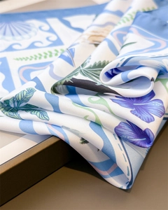 Detail of silk-feel scarf showing soft texture and premium floral tropical prints
