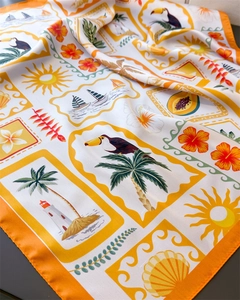 Detailed close-up showing silky satin square scarf with tropical island print and toucan