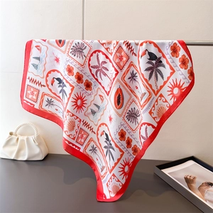 Detail of tropical print silk square scarf showing toucan and palm leaf motifs