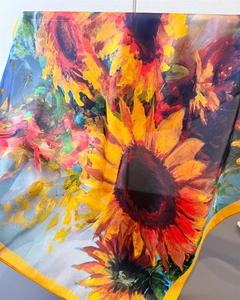 Close-up of bright sunflower oil painting print on silk scarf with yellow hem edge
