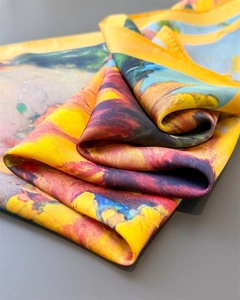 Close-up of artistic sunflower oil painting pattern on smooth silk scarf fabric