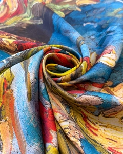 Close-up of artistic sunflower oil painting pattern on smooth satin silk scarf fabric