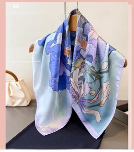 Close-up of sky blue oil painting floral scarf with purple iris print on a wooden hanger